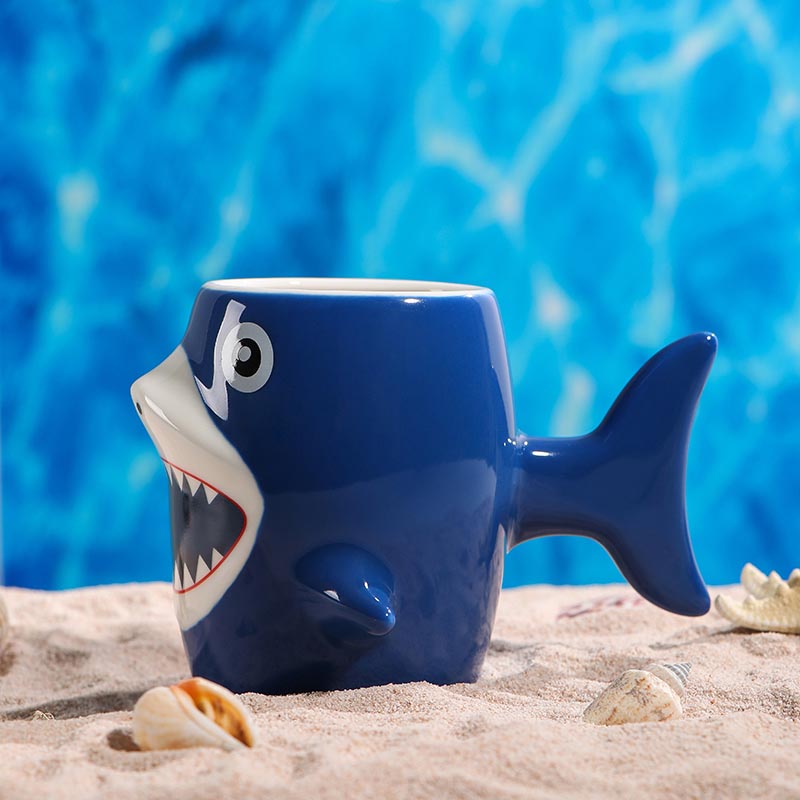 Blue 3D shark ceramic mug 450ml side view on beach - Form Feast
