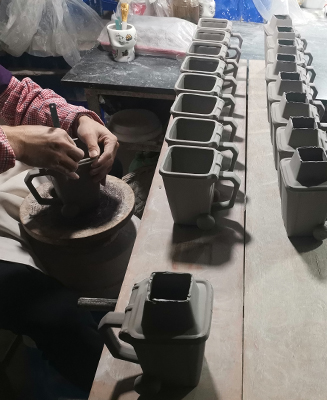 Worker trimming ceramic mugs at Haohan Ceramics Factory - Form Feast