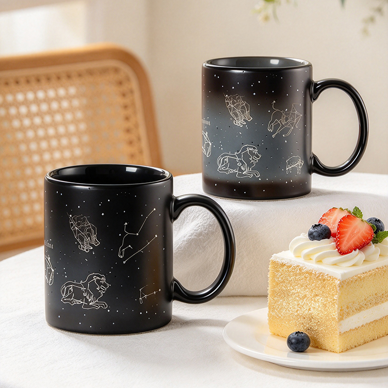 Two black constellation mugs cold state on table - Form Feast