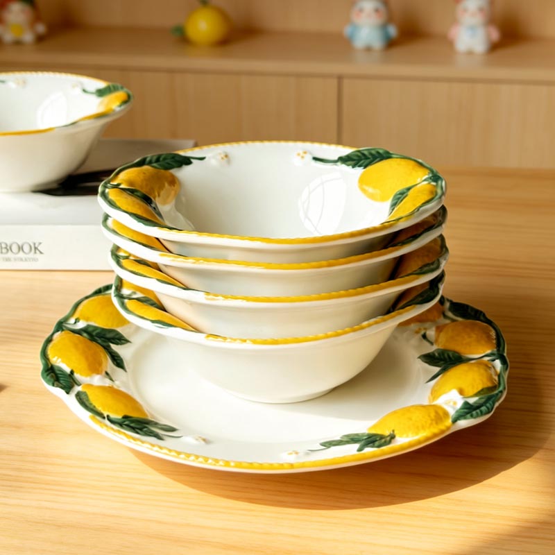Stack of hand-painted lemon ceramic bowls on table - Form Feast
