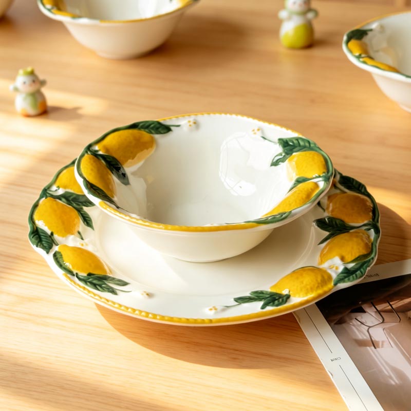 Hand-painted lemon ceramic bowl on plate with lemon pattern - Form Feast