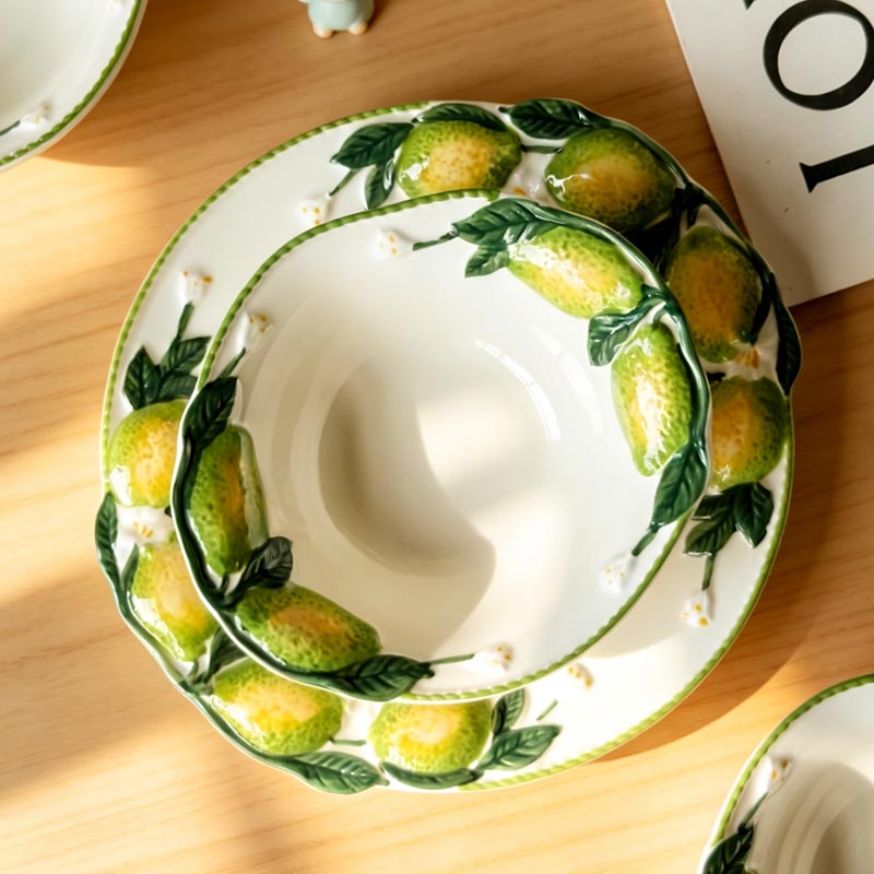 Hand-painted lemon ceramic bowl on plate top view - Form Feast